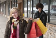 Shot for stock photography. A teenage girl with shopping bags smiles at the camera while a teenage boy looks on.

Click to enlarge photo
