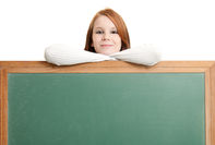 Teen girl leaning on a chalkboard